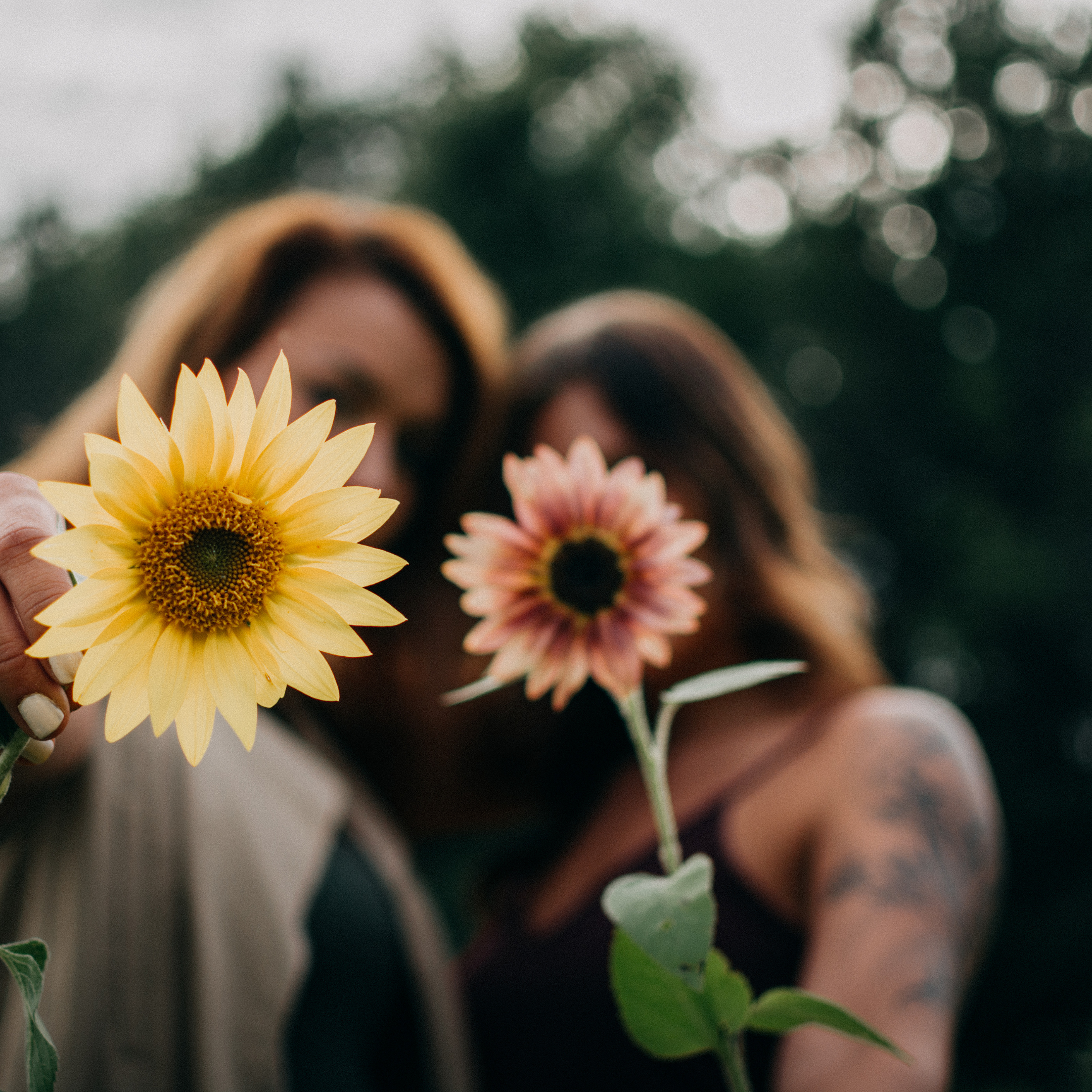 Flowers being held by two women 