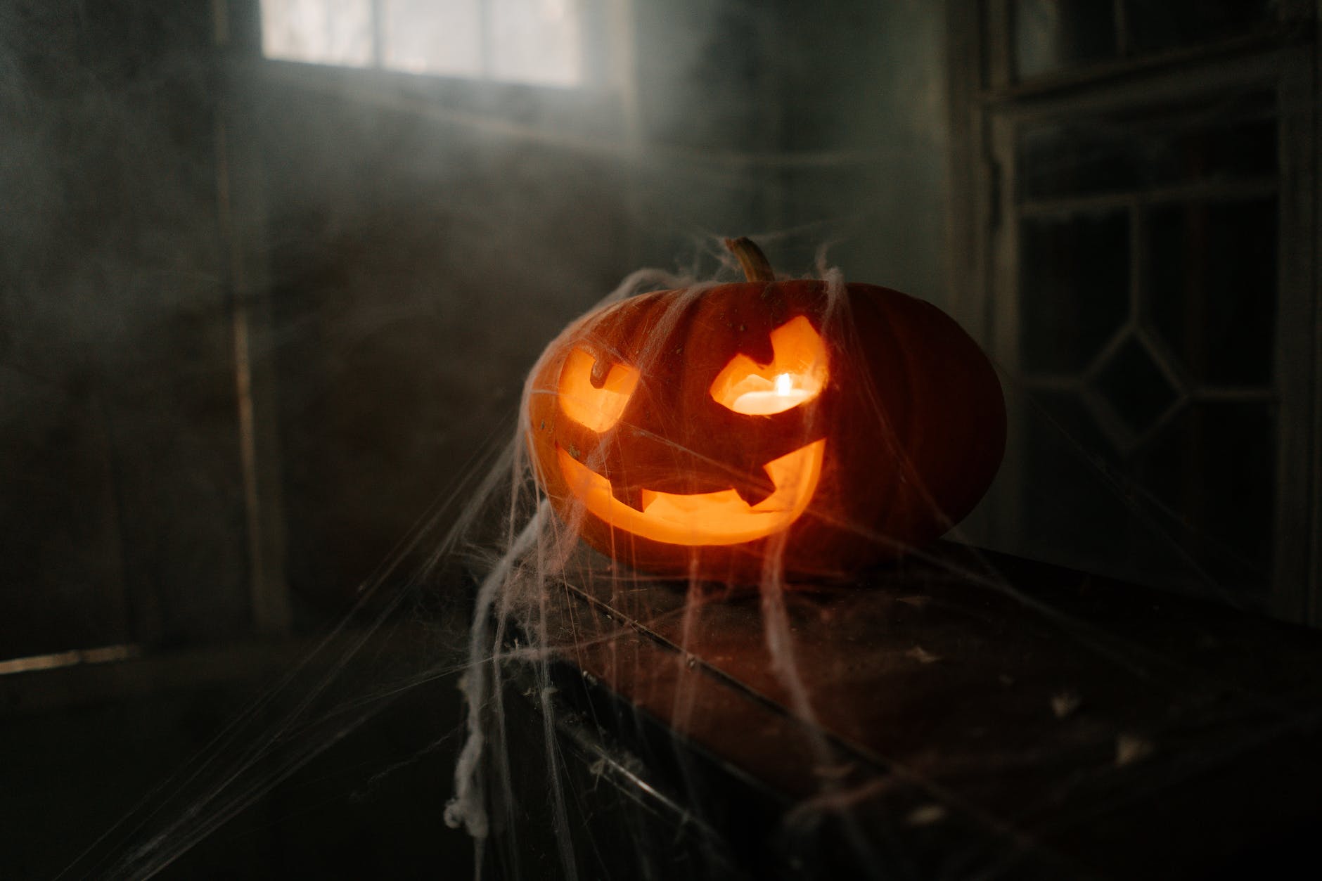 jack o lantern covered in spider web