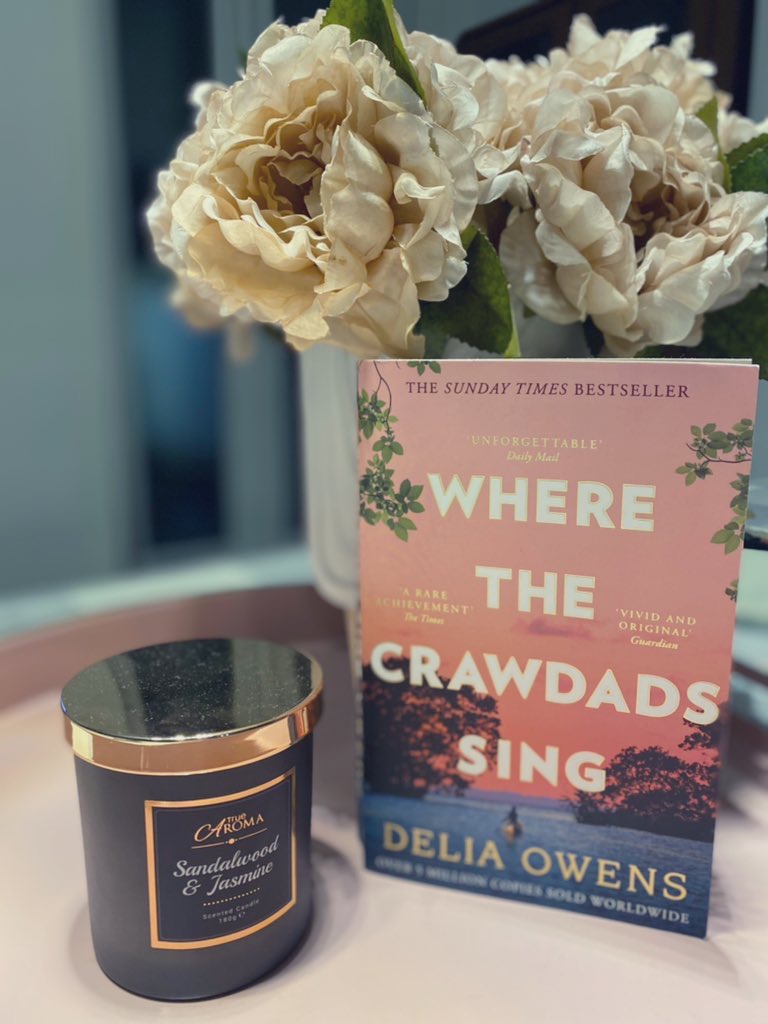 Book with candle and vase of flowers on a pink tray books I got lost in during February