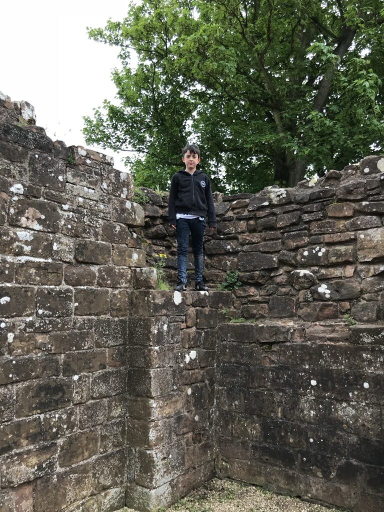 Child climbing on castle gatehouse