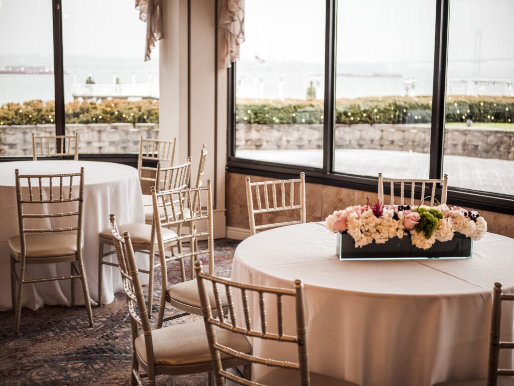 Wedding tables set with a box of flowers in the centre