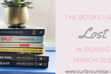 Pile of books with gold pot and green succulent in