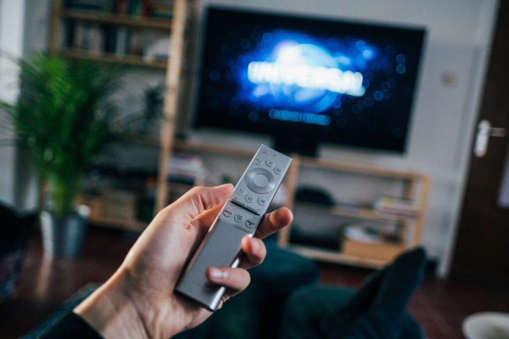 Blurred TV in the background with remote control in hand best celebrity documentaries