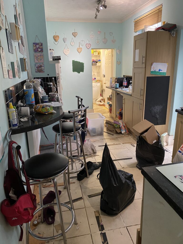 A kitchen full of clutter and rubbish before being redecorated