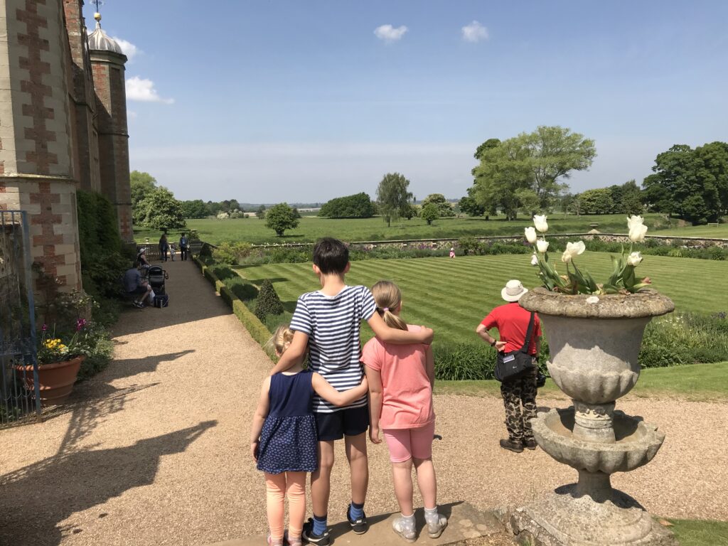 3 children looking out to the Parkland at Charlecote park