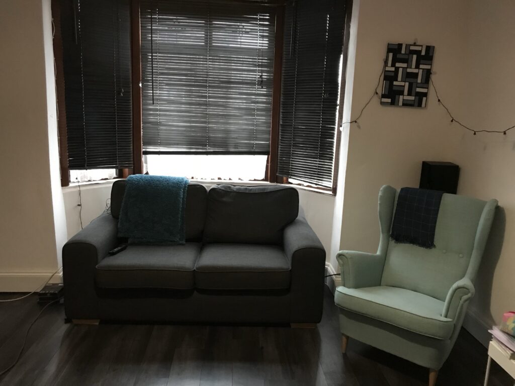 Grey 2 seater sofa with pale green armchair